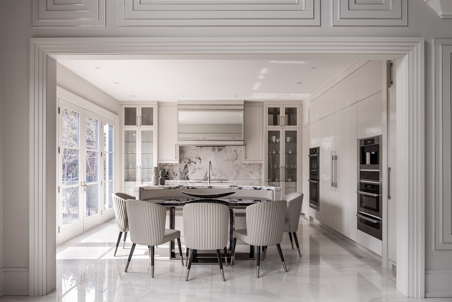Marble kitchen framed by a paneled arch.