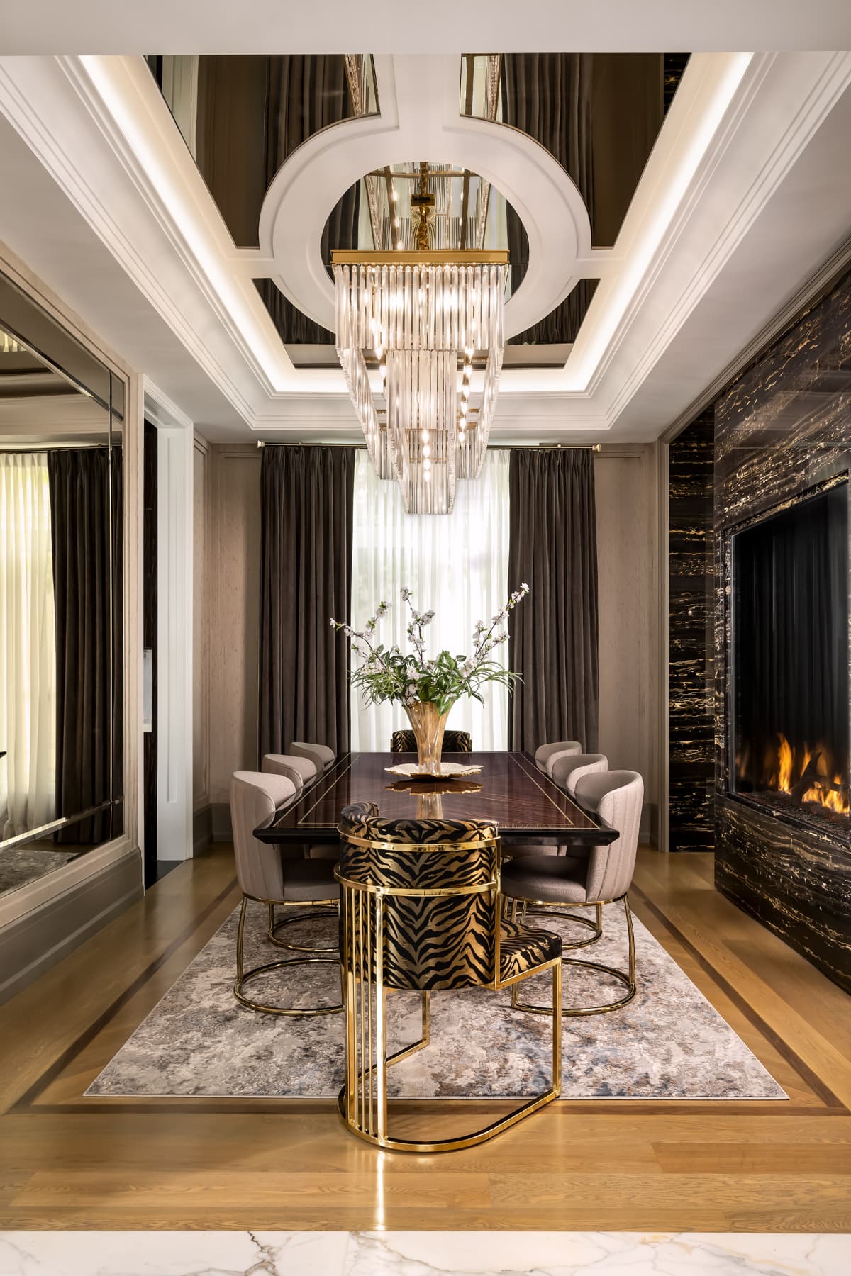 Formal dining room with mirrored coffered ceiling.