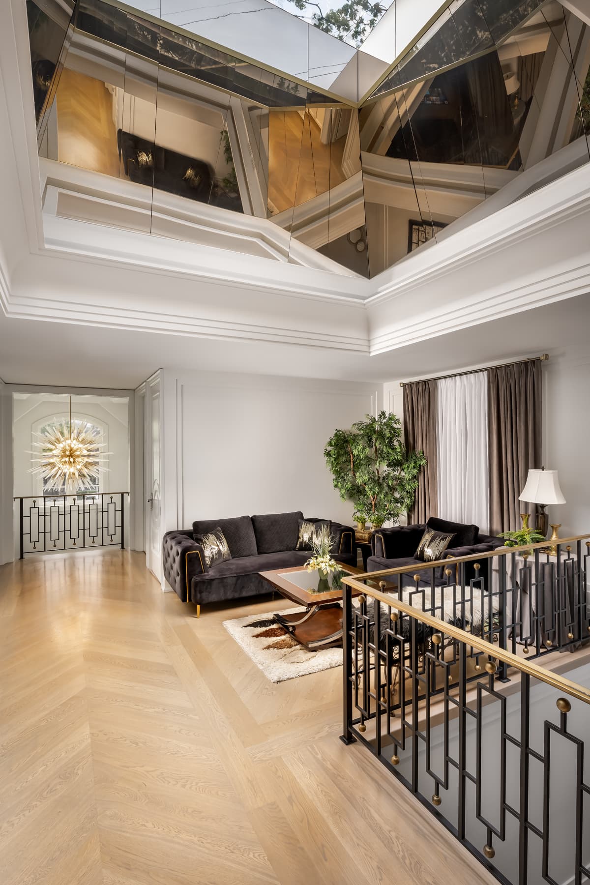 Grand salon with mirrored coffered ceiling and brass framing.