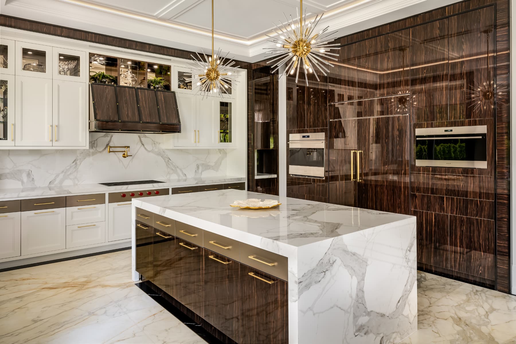 Kitchen detail with brass pot-filler over the cooktop.